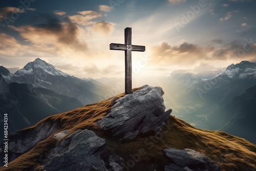 Wooden cross on the top of the mountain with clouds on the background