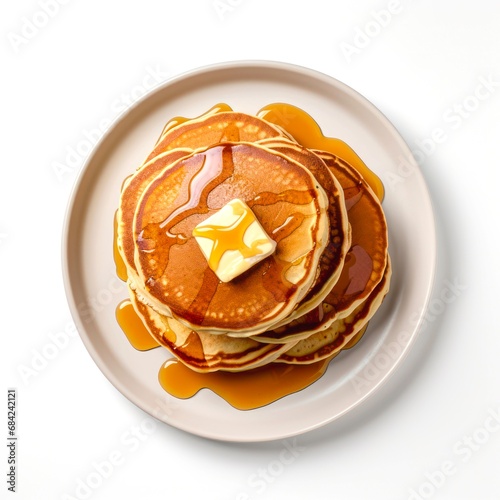 Top view of pancakes with butter and honey on white background.