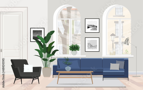 Blue sofa in a Scandinavian apartment with an armchair, coffee table and large windows.