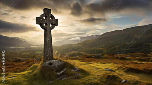 Celtic cross in landscape with mountains	