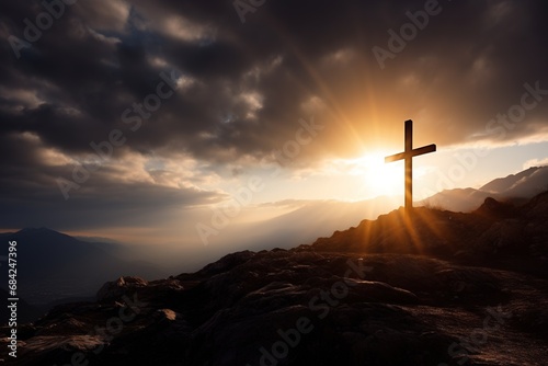 Cross on the rock with dramatic sunset sky background. Christian concept.