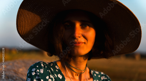 close-up portrait of a girl in a straw yellow hat