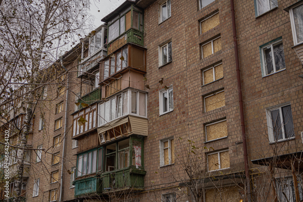 Kyiv, Ukraine - November 26, 2023: windows in a house are covered with plywood