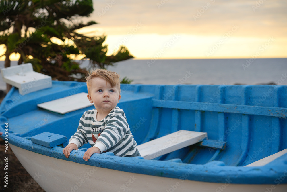 child on a boat at the beach