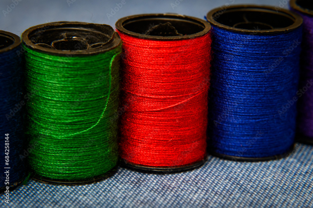 Heap of colorful threads bobbins on table. Heap of colorful threads bobbins on table.