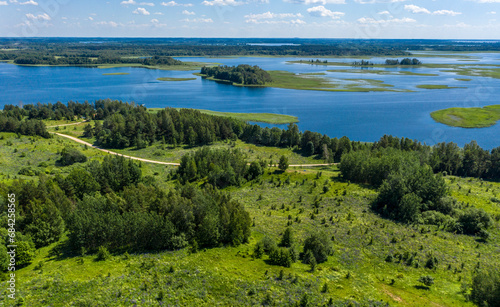 Drone shot on summer lake at dawn. Aerial view of summer landscape lake. 
