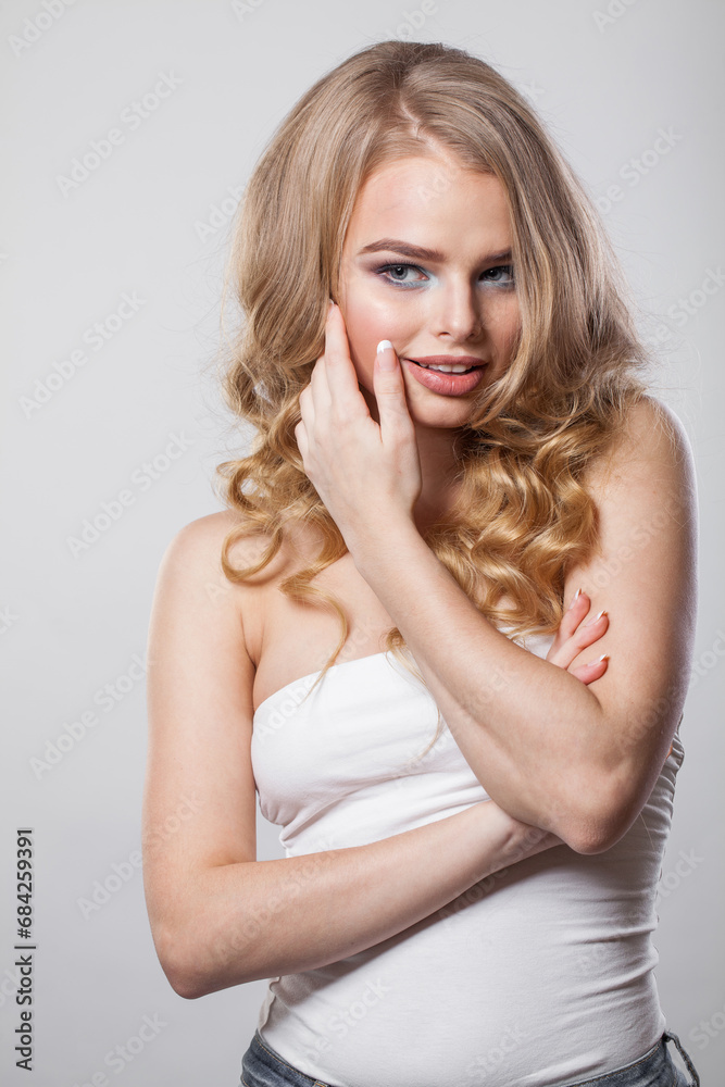 Smiling lady with curly hairdo standing on white background. Beauty woman portrait Smiling lady with curly hairdo standing on white background. Beauty woman portrait
