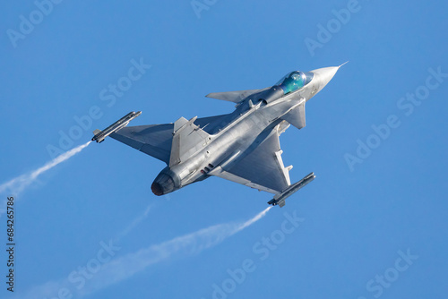 Military fighter jet plane at air base. Airport and airfield. Air force flight operation. Aviation and aircraft. Air defense. Military industry. Fly and flying.