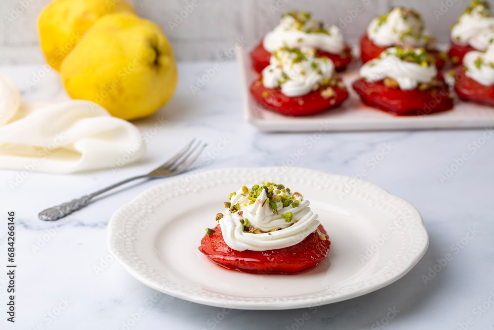Traditional Turkish style quince dessert. The quince is cooked until soft, sherbet is poured on it, and served with cream and walnuts. It is one of the most popular Turkish desserts.(Ayva Tatlisi) Traditional Turkish style quince dessert. The quince is cooked until soft, sherbet is poured on it, and served with cream and walnuts. It is one of the most popular Turkish desserts.(Ayva Tatlisi)
