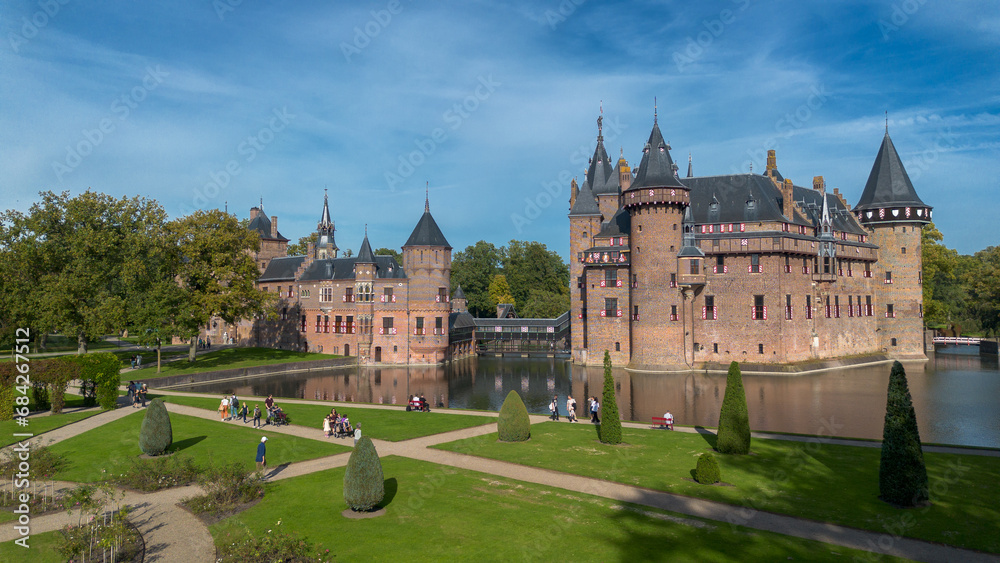Top view of the largest castle in the Netherlands, De Haar. A beautiful quadcopter flight over the castle, the park and the water moat around the castle. A beautiful park in English style.