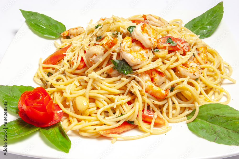Close up of Pasta spaghetti with grilled shrimp bechamel sauce. Spaghetti with seafood rich cream. delicious mediterranean food with salted shrimp, top view, white table italian cuisine. Close up of Pasta spaghetti with grilled shrimp bechamel sauce. Spaghetti with seafood rich cream. delicious mediterranean food with salted shrimp, top view, white table italian cuisine.