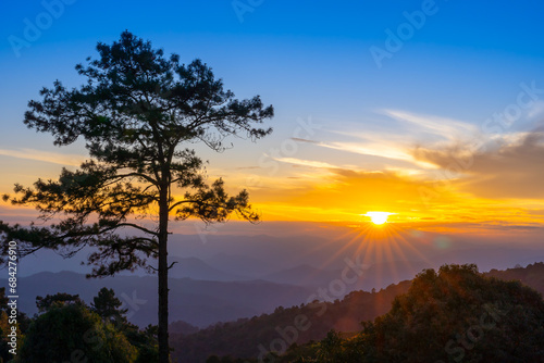 Sun rays shine through trees on a hill mountain in Huai Nam Dang National Park at sunset. View mountain landscape Tourist Attraction in Chiang Mai  Thailand