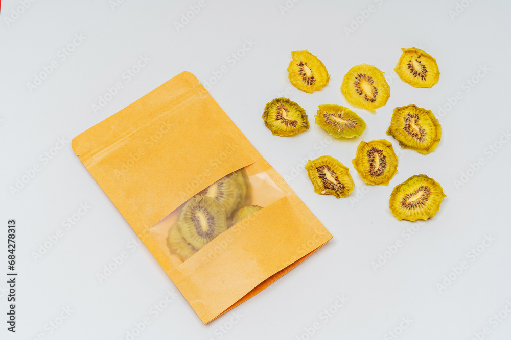dried kiwi slices in a bag on a white background. kiwi dried in a dehydrator for preparing food and drinks. pear chips in a pack on a light background dried kiwi slices in a bag on a white background. kiwi dried in a dehydrator for preparing food and drinks. pear chips in a pack on a light background