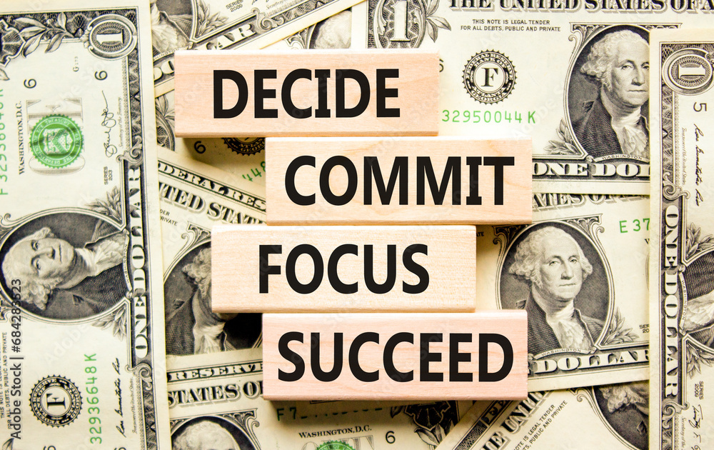 Decide commit focus succeed symbol. Concept word Decide Commit Focus Succeed on block. Dollar bills. Beautiful background from dollar bills. Business decide commit focus succeed concept. Copy space.