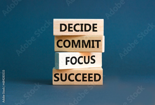 Decide commit focus succeed symbol. Concept word Decide Commit Focus Succeed on wooden block. Beautiful grey background. Business decide commit focus succeed concept. Copy space. photo
