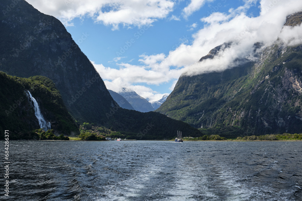 Boat in fjords of milford sound, new zealand Boat in fjords of milford sound, new zealand
