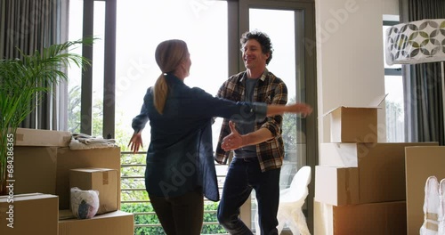 Happy couple, box and hug for new house, interior or apartment in real estate together. Man and woman hugging with boxes for property, investment or relocation and renovation in buying success photo
