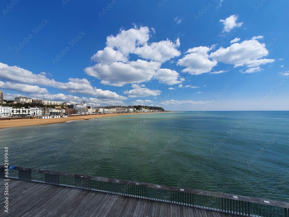 Obraz premium Various Pictures of the Coast at Hastings including the pier and the countryside park and a Cane Corso dog playing under the pier
