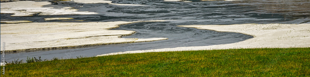Shore of toxic lake in abandoned open pit copper mine. Shore of toxic lake in abandoned open pit copper mine.