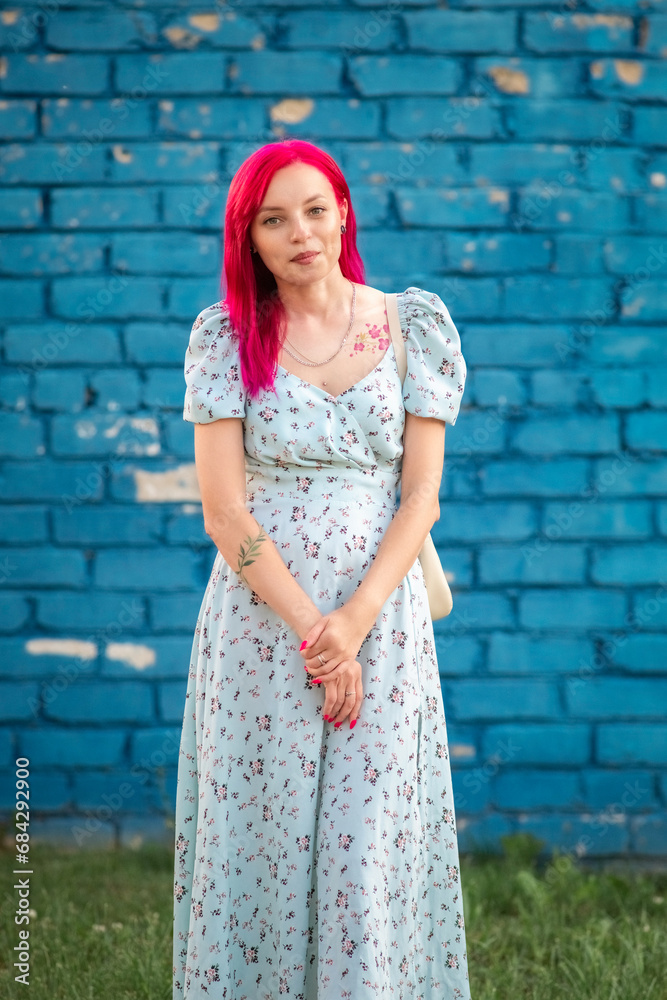 Portrait of a young beautiful girl with red hair in an urban environment. Portrait of a young beautiful girl with red hair in an urban environment.