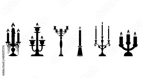 Retro candles in a set of candlesticks. Silhouette of candlesticks on a white background