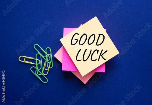 Good luck symbol. Good luck on steaky note. Beautiful deep blue background. Business and Good luck concept. Copy space. photo