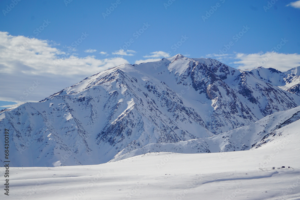 Scenic view of a snow-covered mountain on a beautiful winter day. Andes mountain range, Chile.