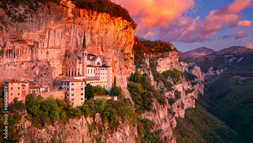Madonna della Corona, Italy. Aerial image of the unique Sanctuary Madonna della Corona (Sanctuary of the Lady of  the Crown) was built in the rock, located in the Alps in Italy at autumn sunrise.