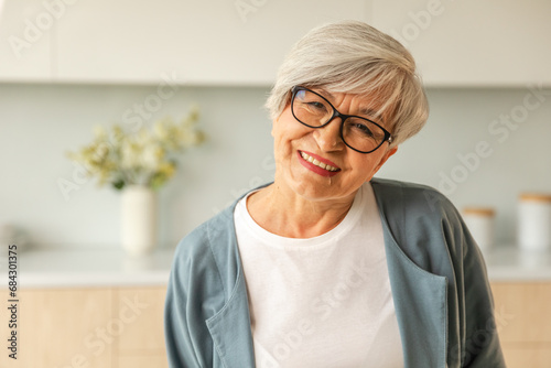 Portrait of confident stylish european middle aged senior woman. Older mature 60s lady smiling at home. Happy attractive senior female looking camera close up face headshot portrait. Happy people