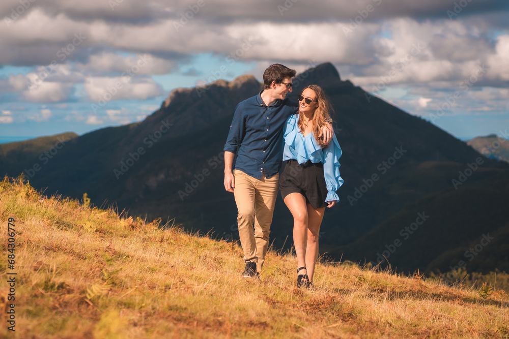 Lovers strolling along a hill in the mountain