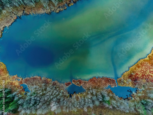 Aerial view of the lake in Lithuanian forests, wild autumn nature. Name of the lake 