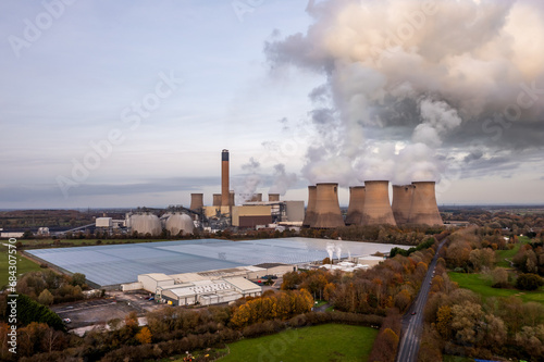 A coal fired power station and factory with carbon dioxide emissions and poisonous cloud photo