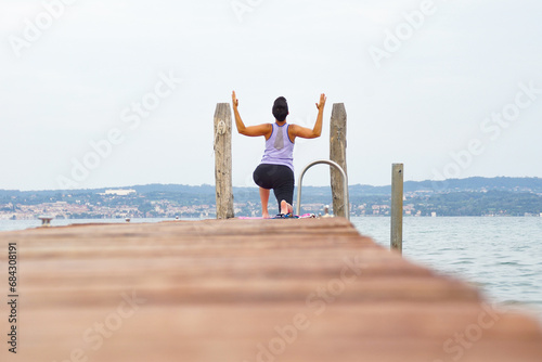 person practicing yoga on beach photo