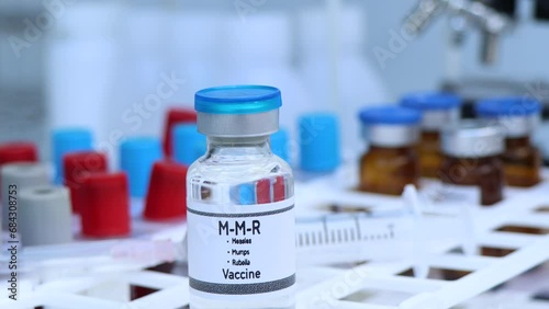 Measles, Mumps, Rubella vaccine in a vial, immunization and treatment of infection, scientific experiment photo