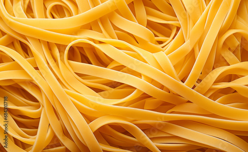 Freshly cooked homemade strand pasta, specifically spaghetti, to create a texture suitable for use as a background or wallpaper