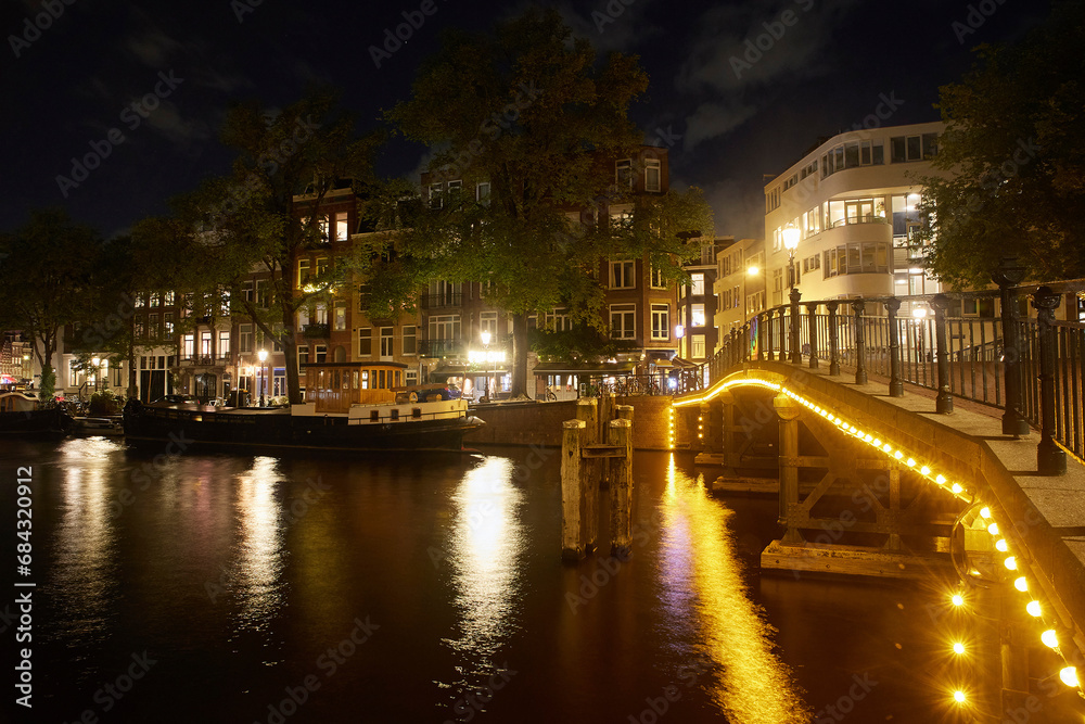 Majestic Amsterdam at night. Summer city landscape. Panorama.