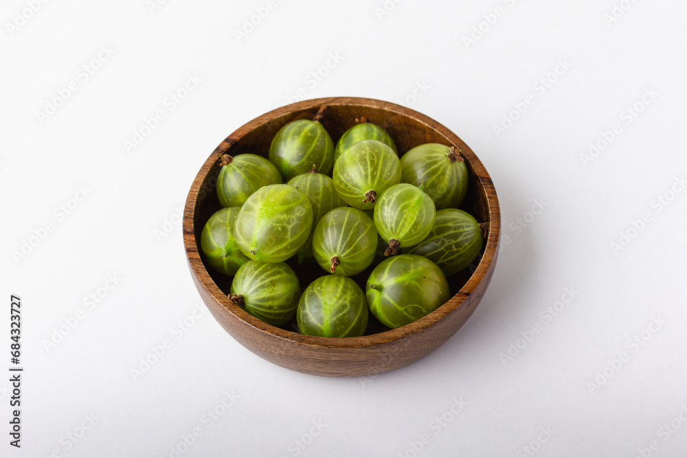 Fresh green gooseberry berries on a white background Fresh green gooseberry berries on a white background