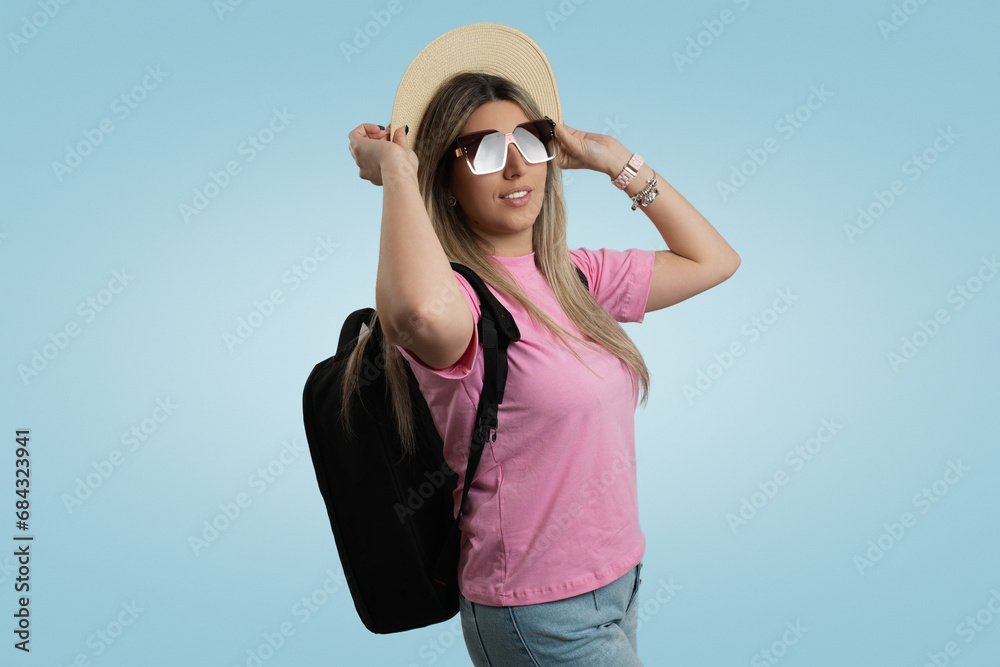 Smiling Woman in Casual Clothing with Blue Cap and Sunglasses Against Colored Backdrop Smiling Woman in Casual Clothing with Blue Cap and Sunglasses Against Colored Backdrop