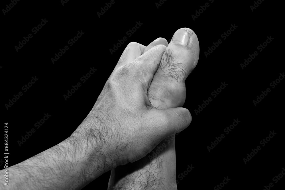 Male hand holding male feet Male hand holding male feet
