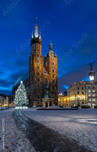 St Mary s church on snow covered Main Square in winter Krakow  illuminated in the night