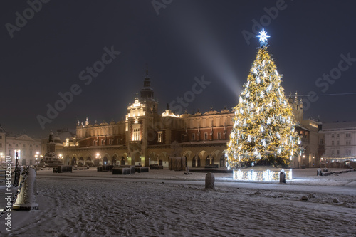 Krakow, Poland, snowy Main Market square and Cloth Hall in the winter season, decorated with Christmas tree