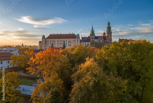 Wawel castle and cathedral over colorful autumn park in the morning sun  Krakow  Poland