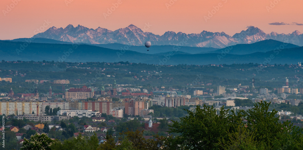 Krakow cityscape in the valley, with Beskidy and Tatra mountains in the background in the evening, Poland, Europe