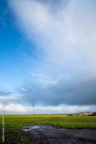 Beautiful image of a Cumulonimbus storm cloud with rain streaks over the Dutch countryside