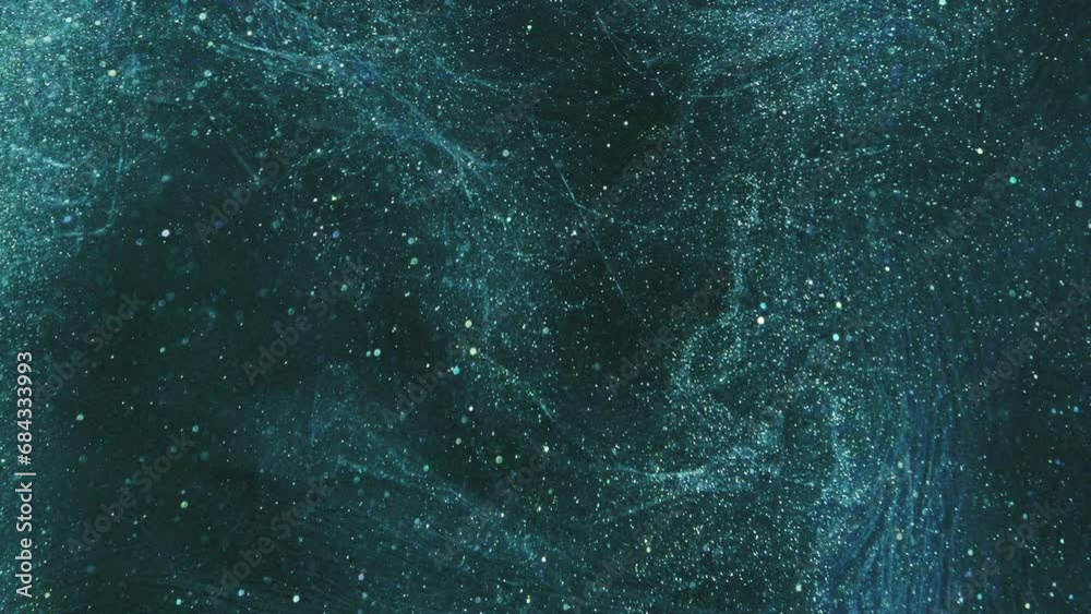 Vertical video. Glitter abstract background. Night stars. Galaxy universe. Teal blue shimmering shiny bokeh sparkles ink flow spreading glowing in black art. Vertical video. Glitter abstract background. Night stars. Galaxy universe. Teal blue shimmering shiny bokeh sparkles ink flow spreading glowing in black art.