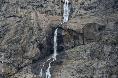 A triple waterfall  the result of melting glaciers   comes from thousands of feet above in Greenland