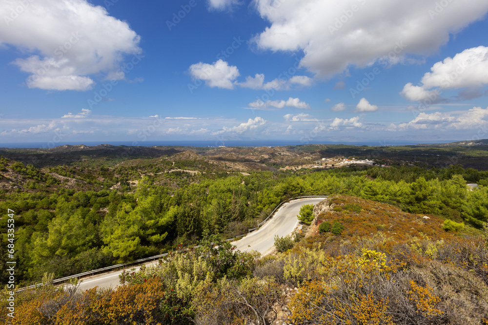 Inland landscape on the island of Rhodes. Wooded hills and roads leading between low forests. Inland landscape on the island of Rhodes. Wooded hills and roads leading between low forests.