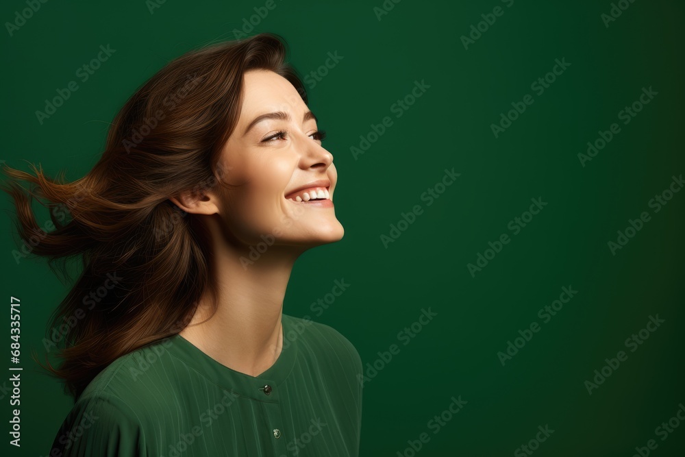 Beautiful happy woman on green background looking to the side Beautiful happy woman on green background looking to the side