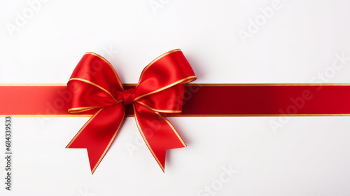 Red ribbon and bow with gold isolated against white background