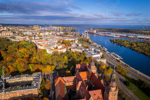 Szczecin from a bird's eye view on a sunny day. View of the city from the Oder River. City buildings, the seaport in Szczecin and its most characteristic places.